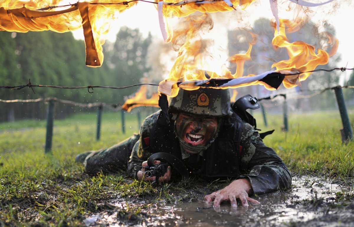 later-in-the-training-the-paramilitary-police-also-have-to-crawl-under-fire-obstacles-